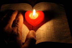 hands with candle, bible