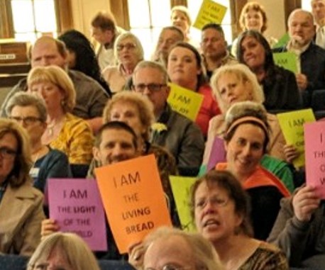 congregation holding sign